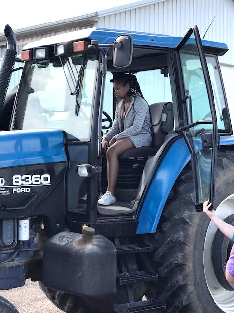 Girl riding a tractor